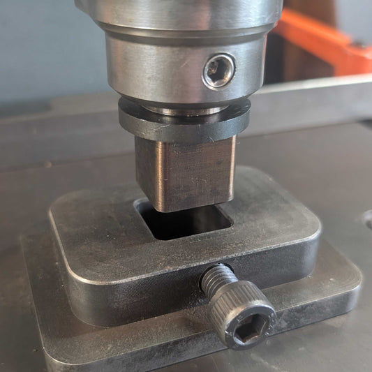 Fly Press Alignment and Indexing tool mounted in a tool holder positioned above a hardie base plate.
