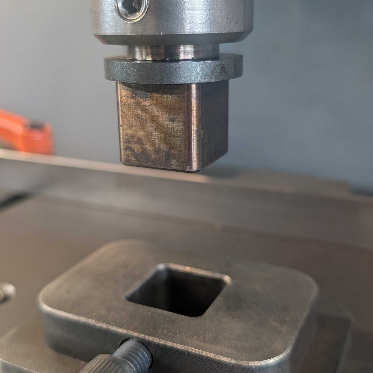 Fly Press Alignment and indexing tool inserted into the power forge tool holder above a hardie base plate.