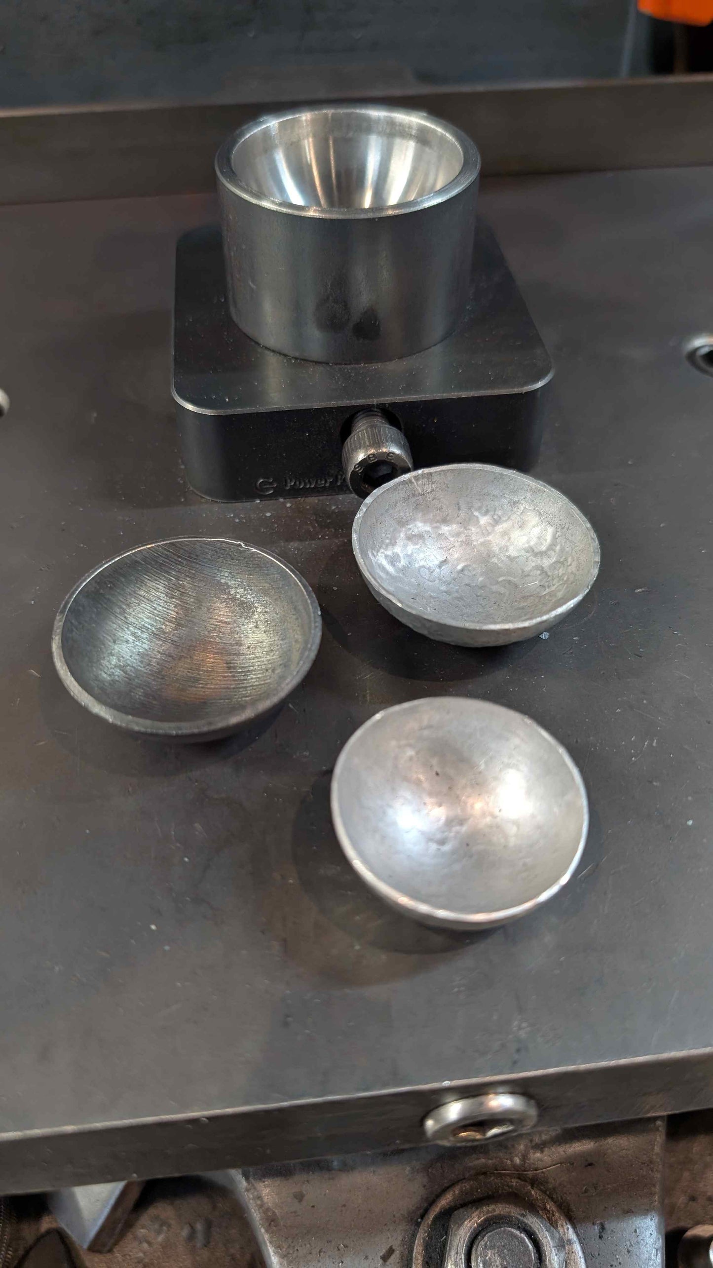 Bottom forming die with three formed coffee spoons.