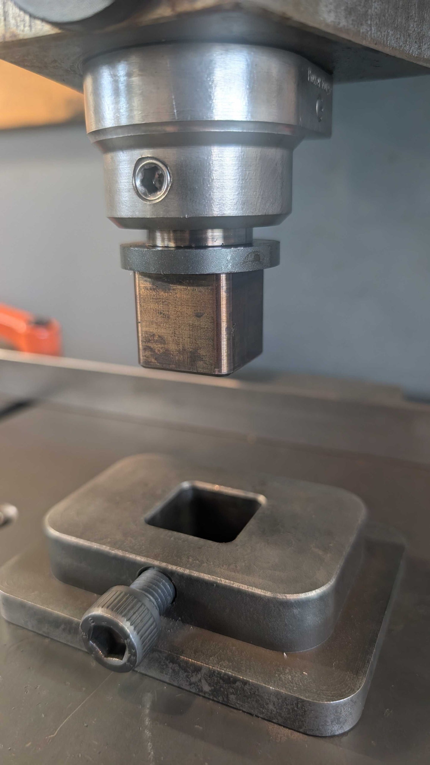 Fly Press Alignment and indexing tool inserted into the power forge tool holder above a hardie base plate. 