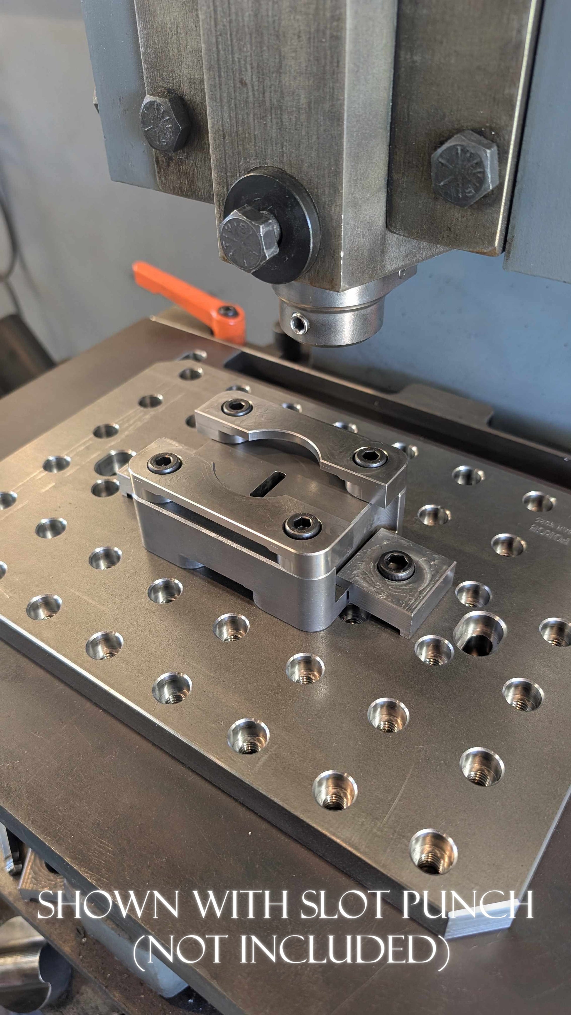 Metalworking machine with slot punch attachment on a workbench