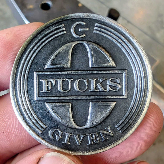 A stainless steel coin that says zero fucks given. 