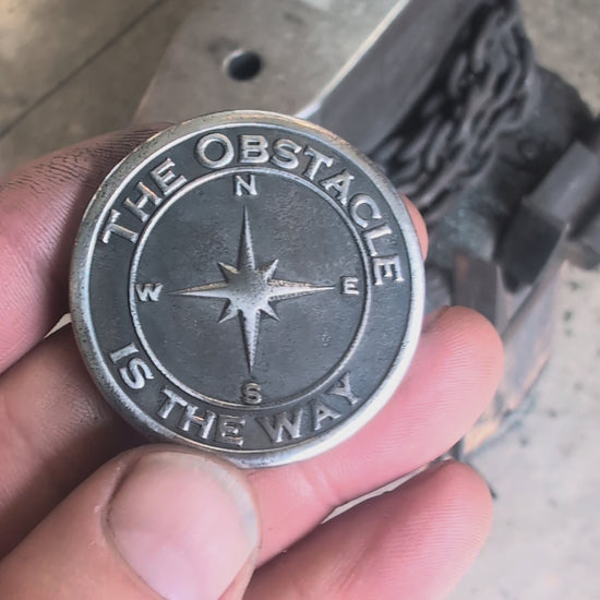 Video of Stoic Coin with the phrase The Obstacle is the Way and Embrace the suck.